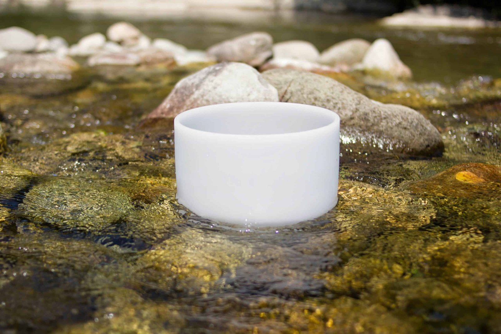 crystal,singing,bowl,into,the,river.,meditation,and,relax.