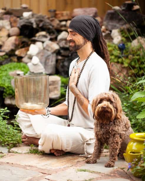 new age man with smokey quartz crystal singing bowl, sound healing