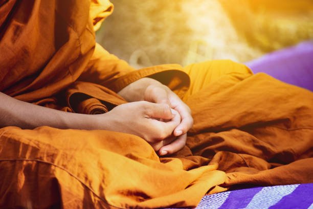 buddhist monk vipassana meditate to calm the mind in thailand.